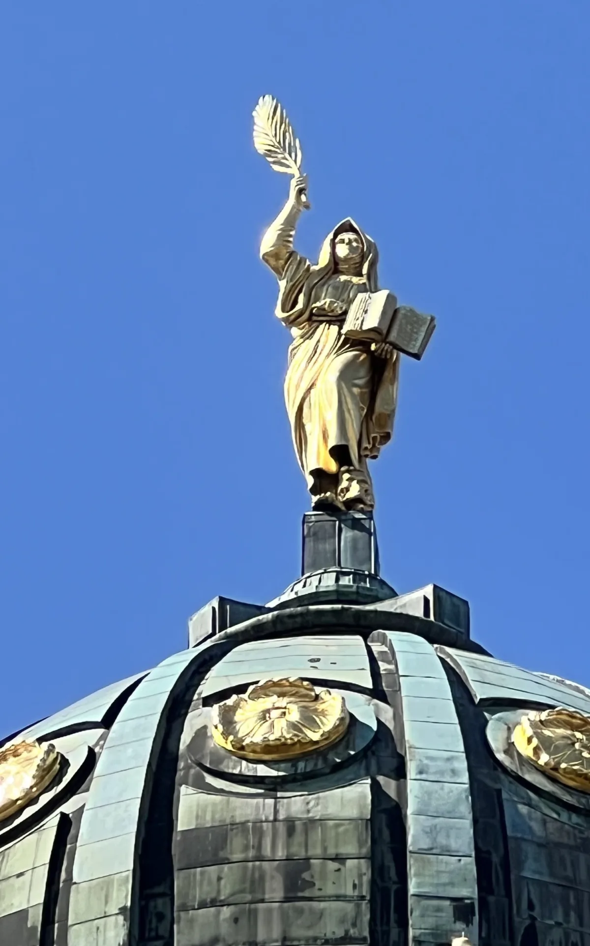The golden goddess on the dome of the French Cathedral, Gendarmenmarkt Berlin — close-up